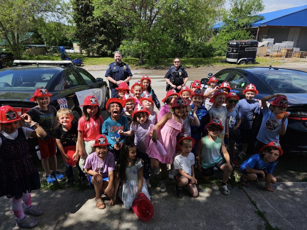 Police Officers posing with local students